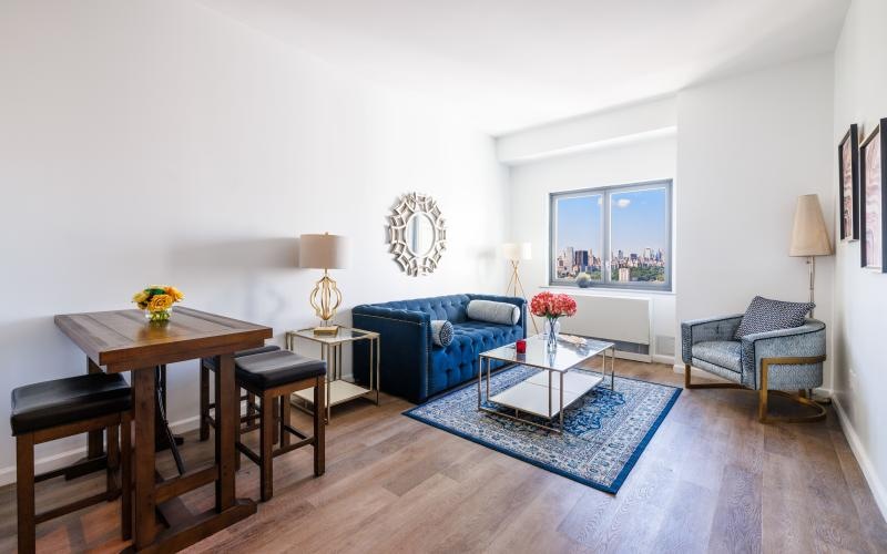 a living room with a blue couch and a table